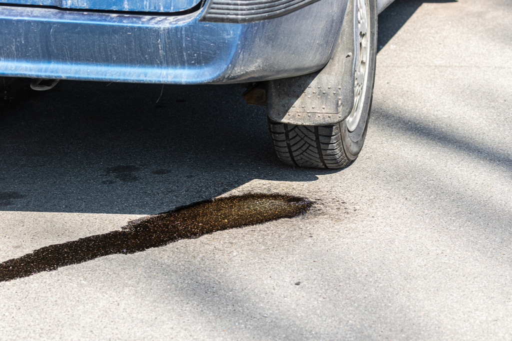 car leaking fluid on asphalt