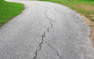 asphalt road cracked. street in public park