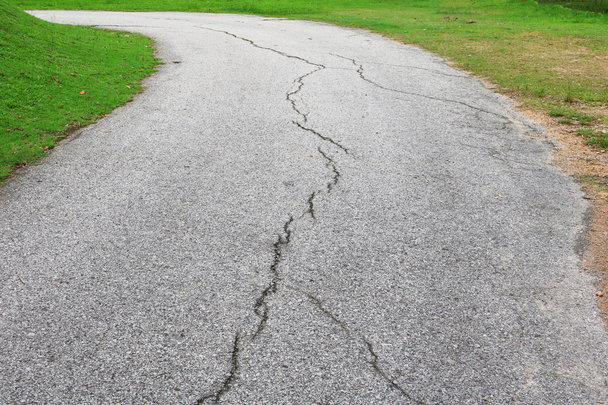 asphalt road cracked. street in public park