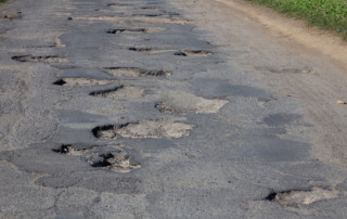 Damaged surface of the asphalt road