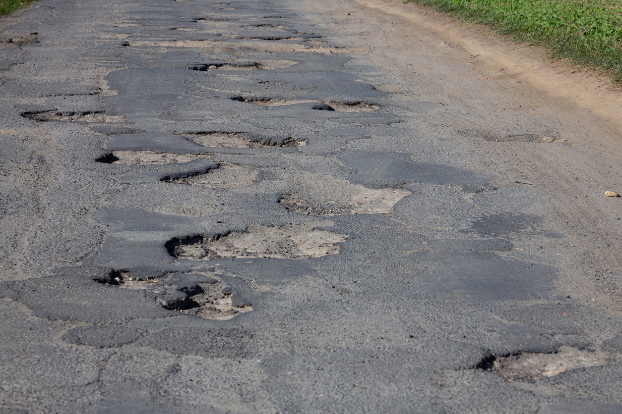 Damaged surface of the asphalt road