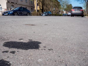 Oil leakage from old car on the Street