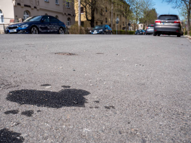 Oil leak from old car on the street