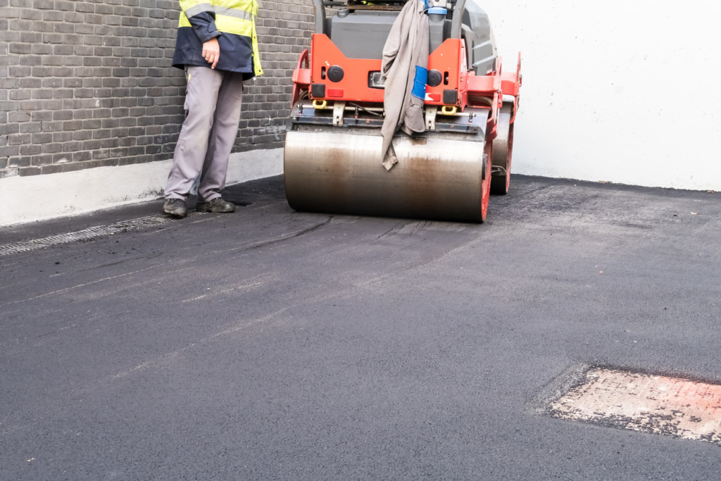 an asphalt roller paving a new road