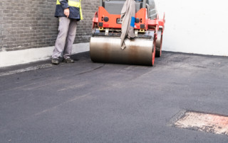 an asphalt roller paving a new road