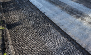 an asphalt street under renovation with milled tarmac