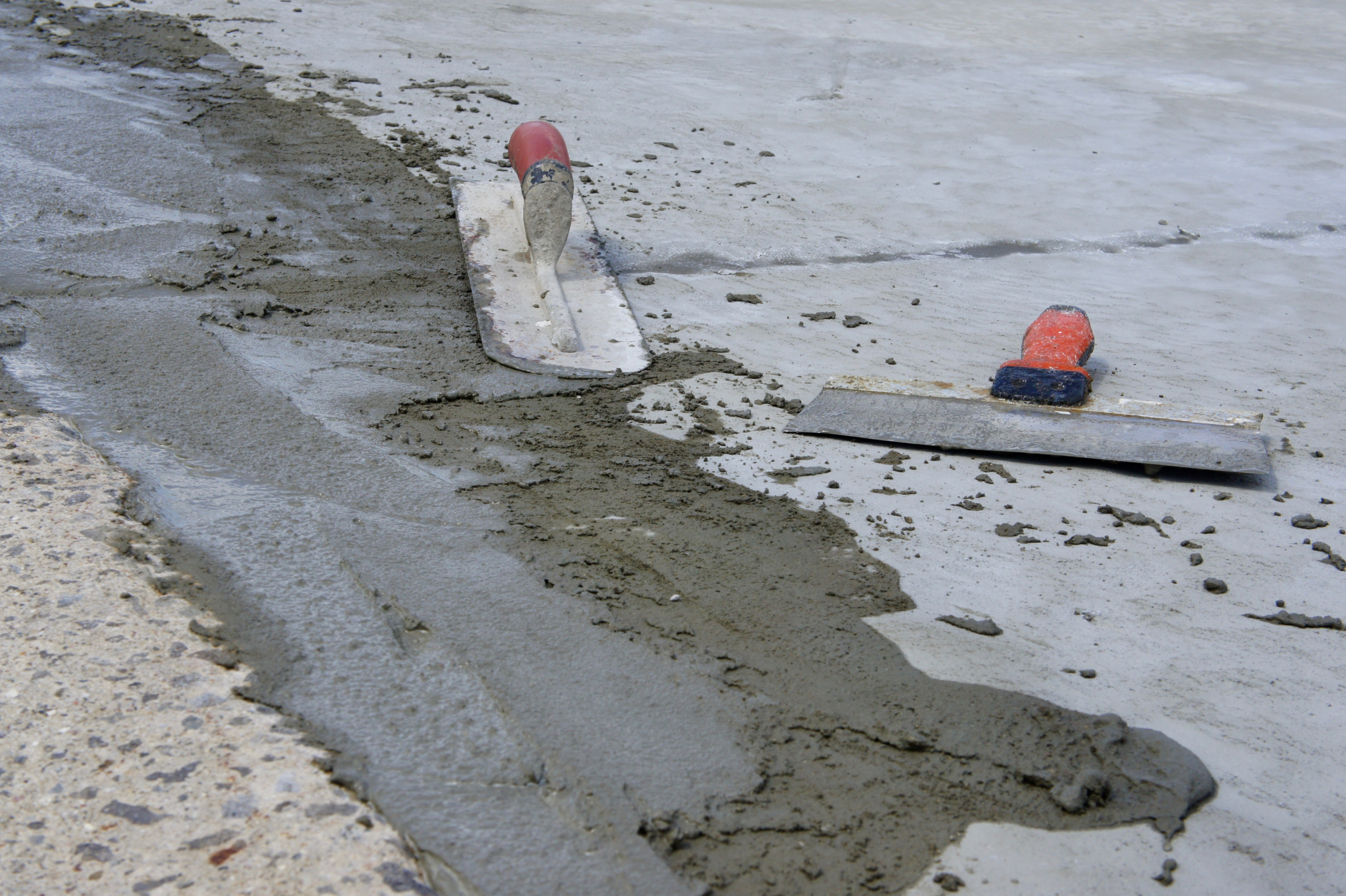 Wet concrete with hand trowels