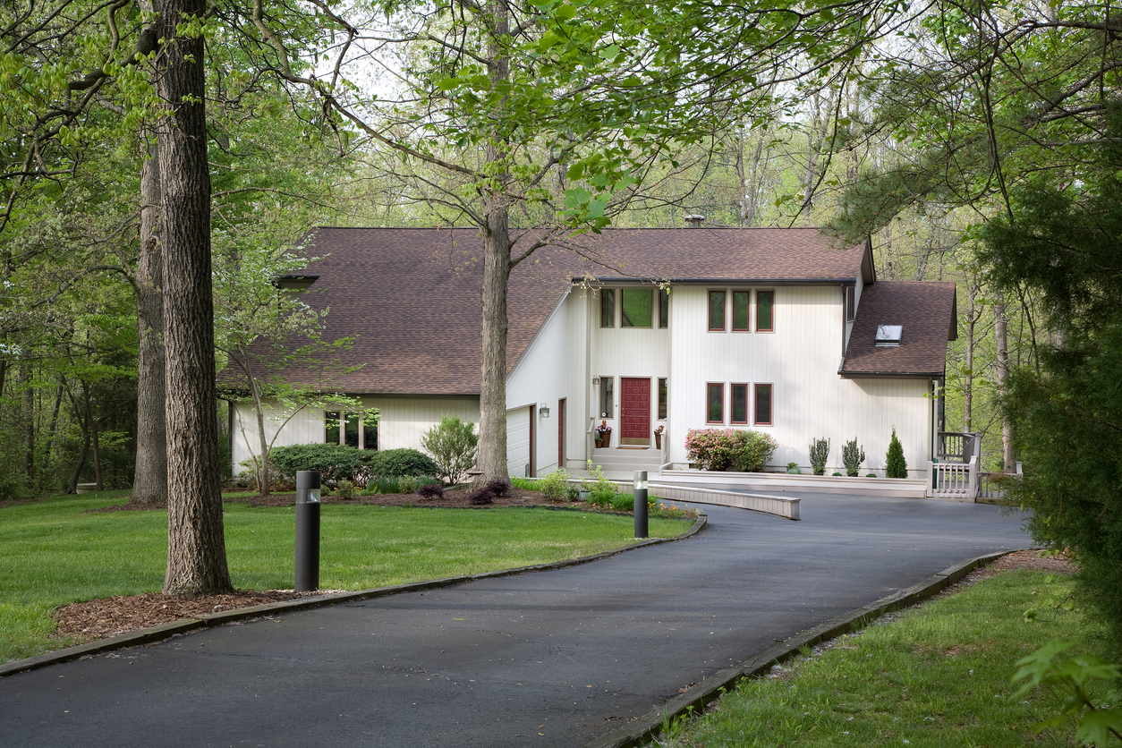 large home among trees with a long driveway
